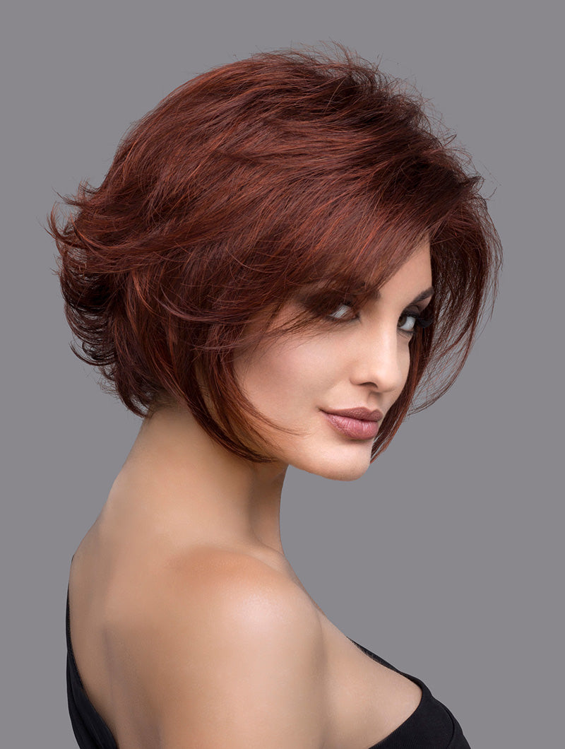 headshot of model wearing red chin length wig