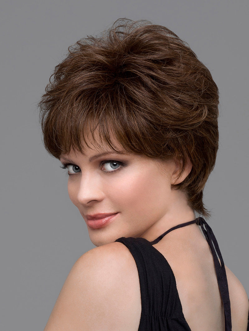 headshot of model wearing brown pixie style wig