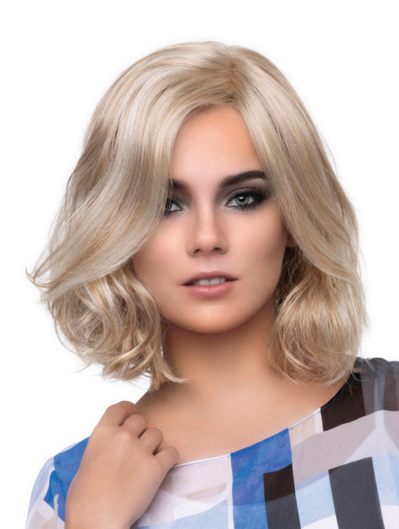 headshot of model wearing blonde chin length wig
