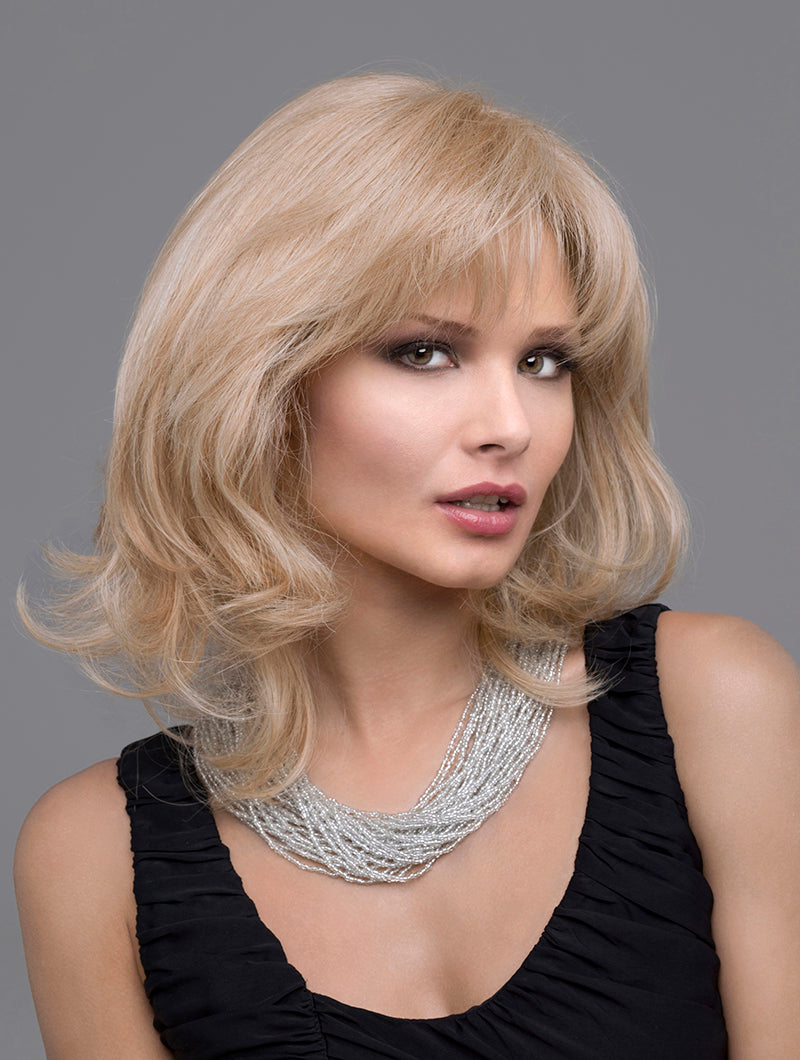 headshot of model wearing blonde shoulder length wig