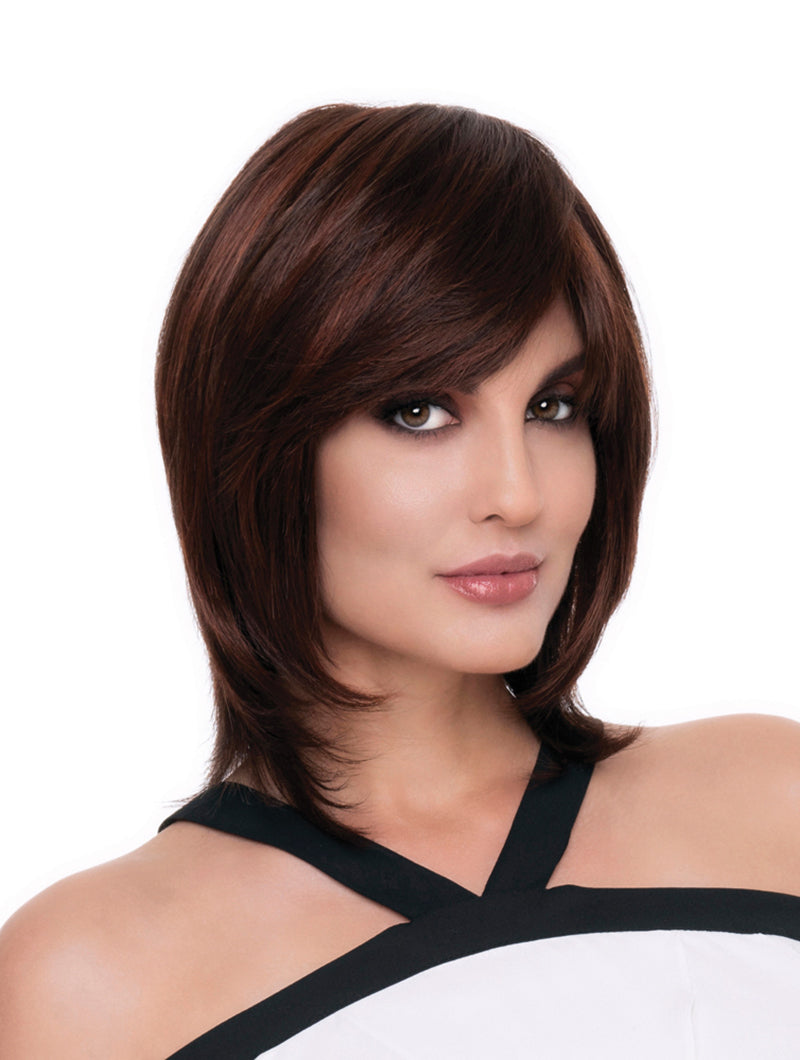 headshot of model wearing dark reddish brown chin length wig with layers