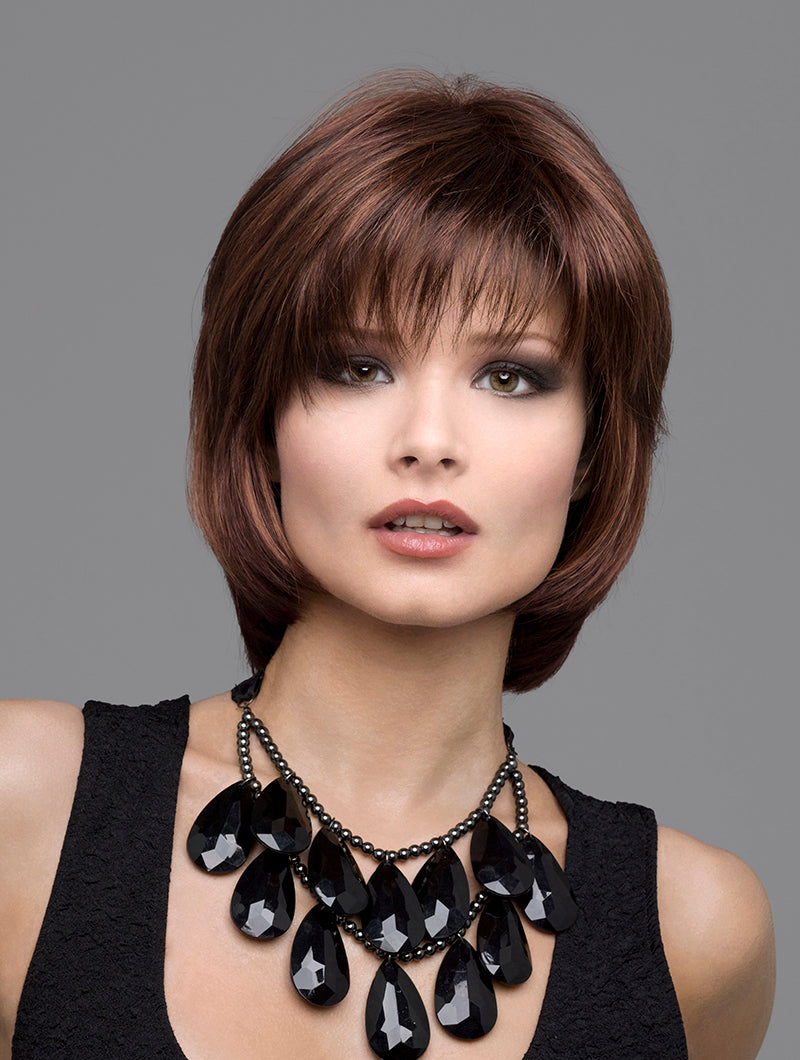 headshot of model wearing brown chin length wig