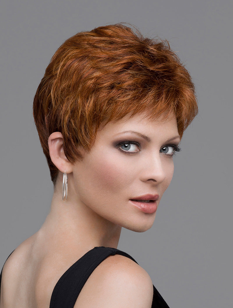 headshot of mode wearing red pixie style wig
