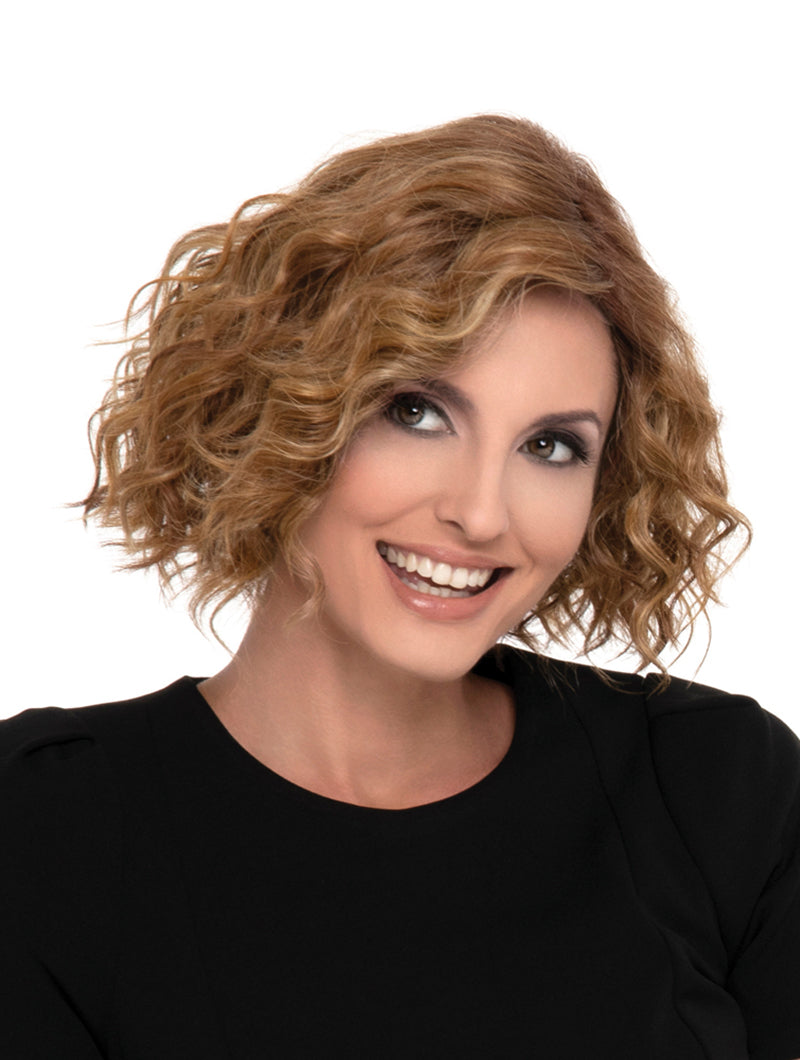 headshot of model wearing curly red wig