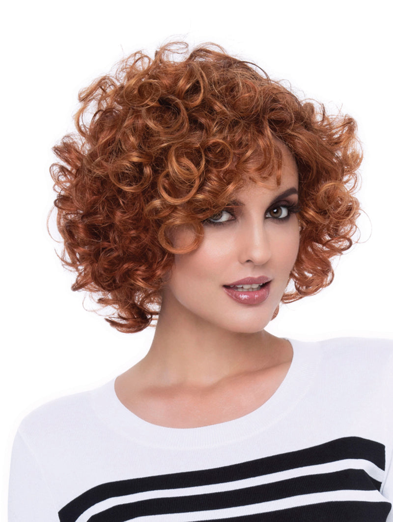 headshot of model wearing short red wig with curls