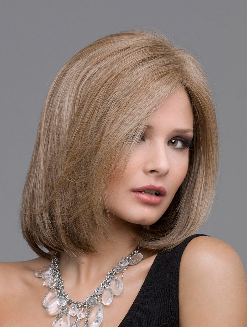 headshot of model wearing light brown bob style wig
