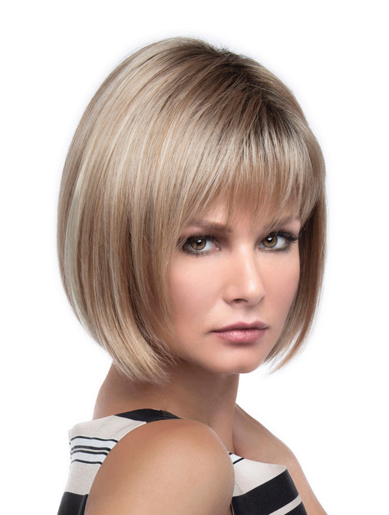 headshot of model wearing blonde chin length wig with bangs