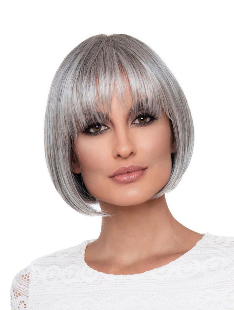 Headshot of model wearing grey bob style wig with bangs