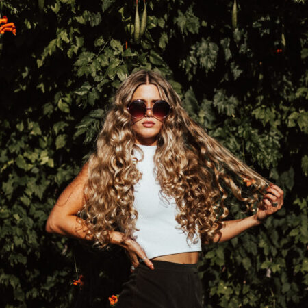 woman with curly hair wearing sunglasses