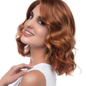 headshot of model looking over her shoulder with red curly wig