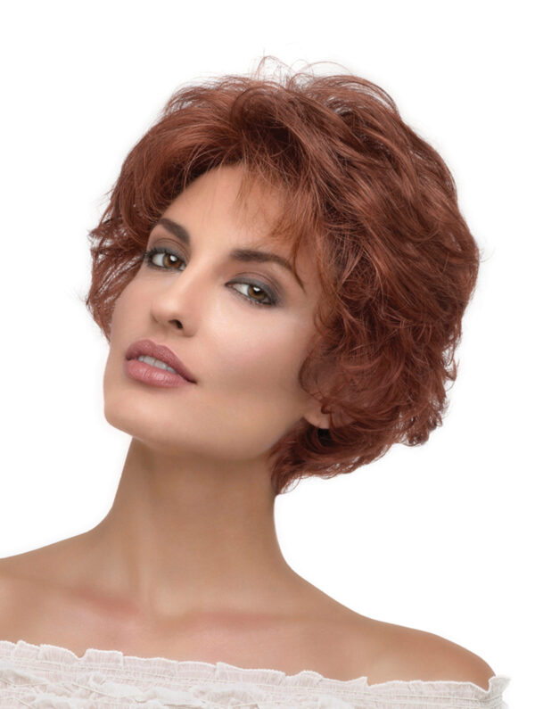 headshot of model wearing short curly red wig