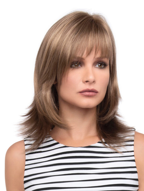 headshot of model wearing dark blonde shoulder length wig