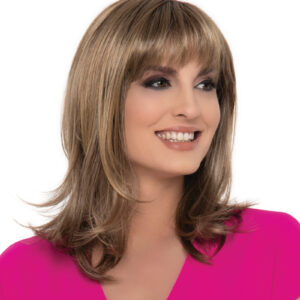 headshot of model wearing layered shoulder length wig with bangs