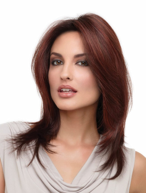 shoulders up view of model wearing dark red shoulder length layered wig