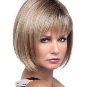 headshot of model wearing blonde chin length wig with bangs